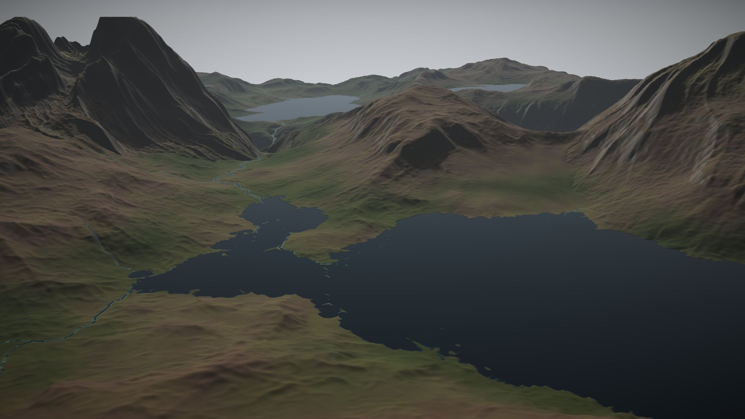 Aerial view across a sea loch towards eroded highland massifs