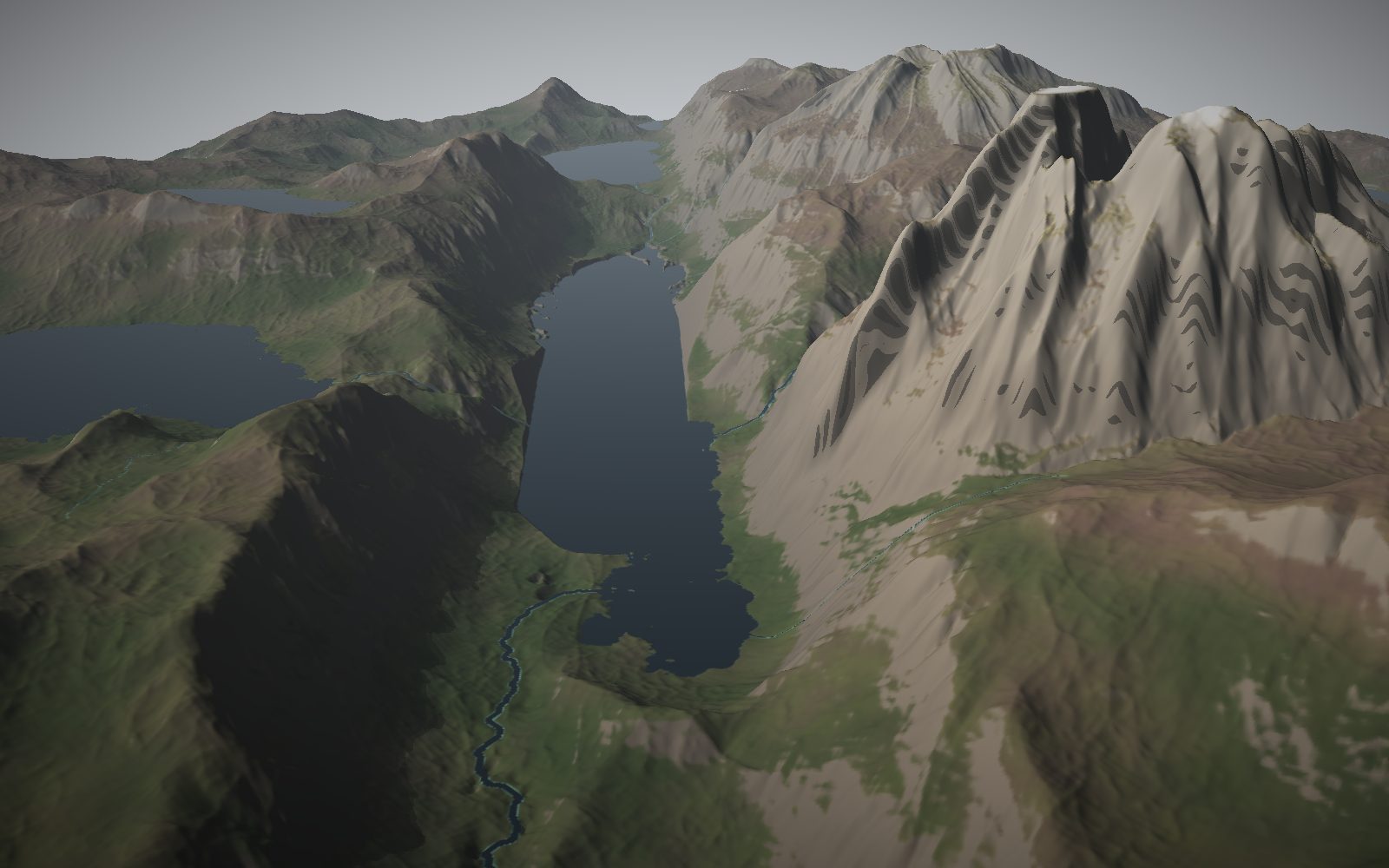 A glen with a river running into a loch between mountains